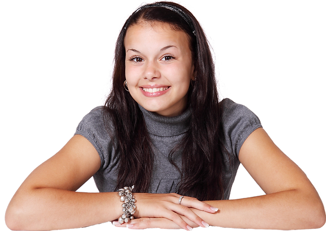 Young woman with long hair posing with hands on hips against a white background.